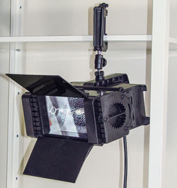Mobile video lighting unit attached to a horizontal metal bar.